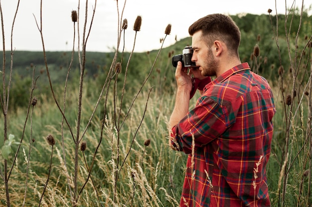 Side view man taking photos