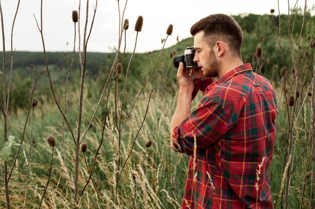 Side view man taking photos