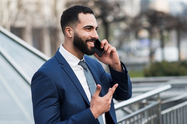 Side view man talking over phone