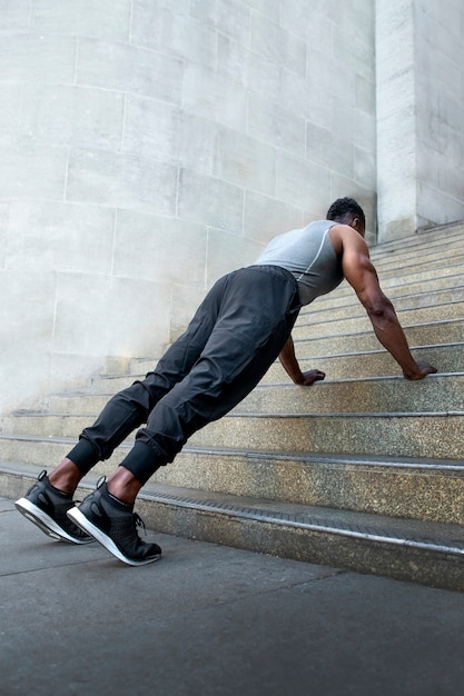 Side view man training with stairs