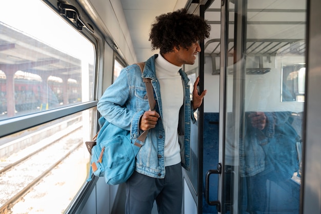 Free photo side view man traveling by train