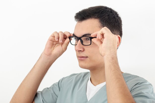 Side view of man trying on his glasses