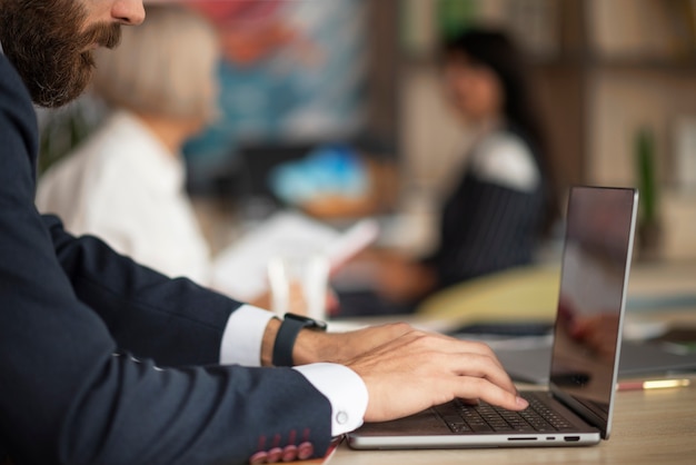 Free photo side view man typing on keyboard