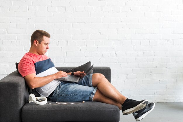 Side view of a man using laptop