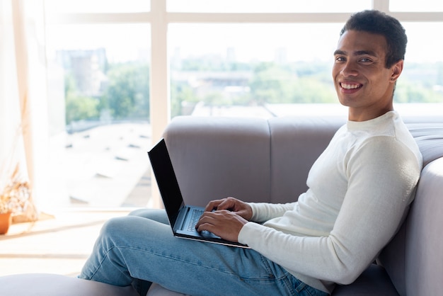 Side view of man using laptop