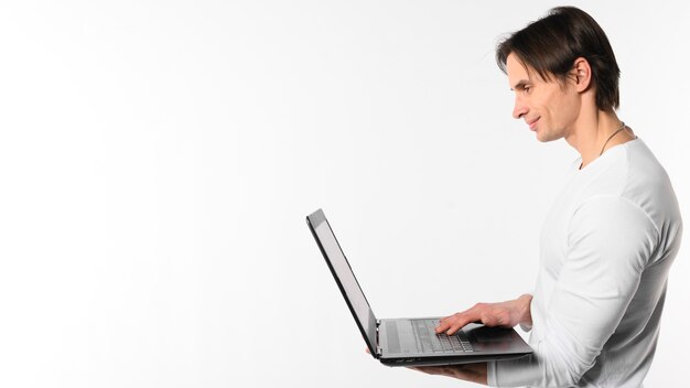 Side view man using laptop