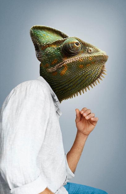 Side view man wearing chameleon head