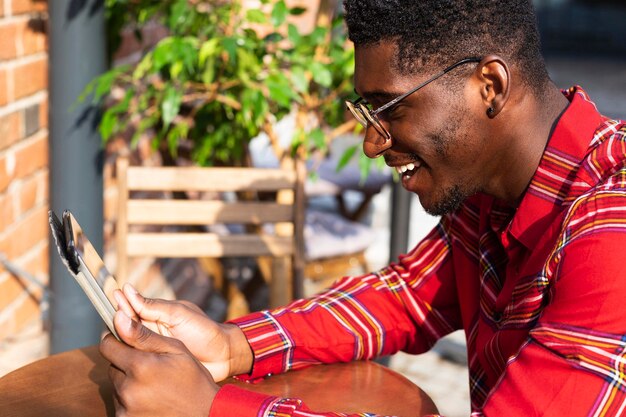 Side view man wearing glasses and reading