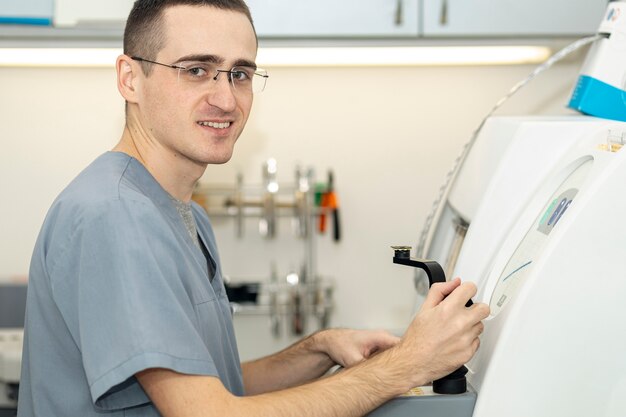 Side view of man wearing glasses working on equipment