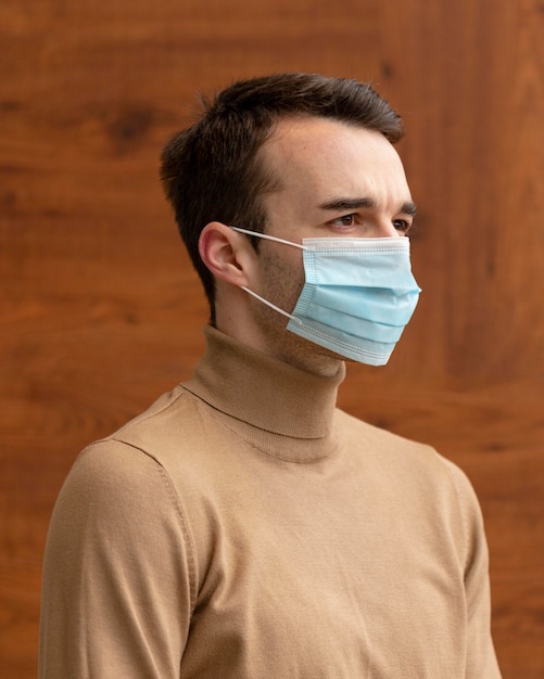 Side view of man wearing a medical mask