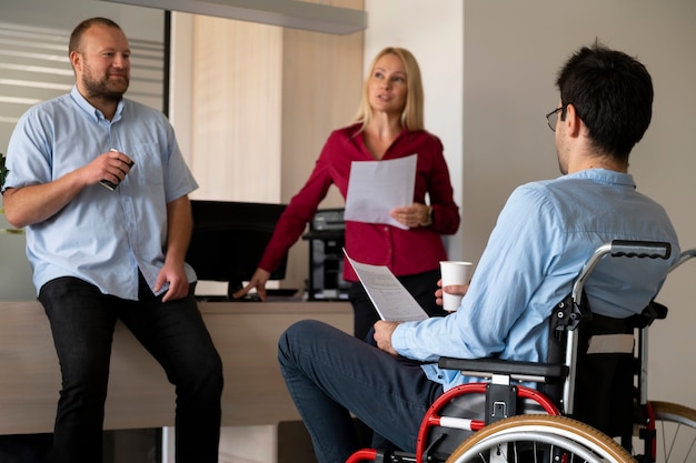 Side view man in wheelchair at work