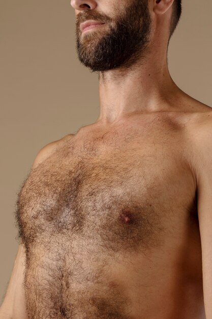 side view man with chest hair posing