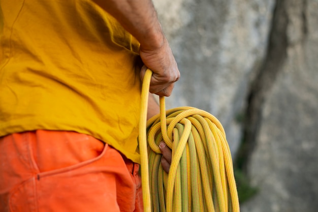 Side view man with climbing equipment