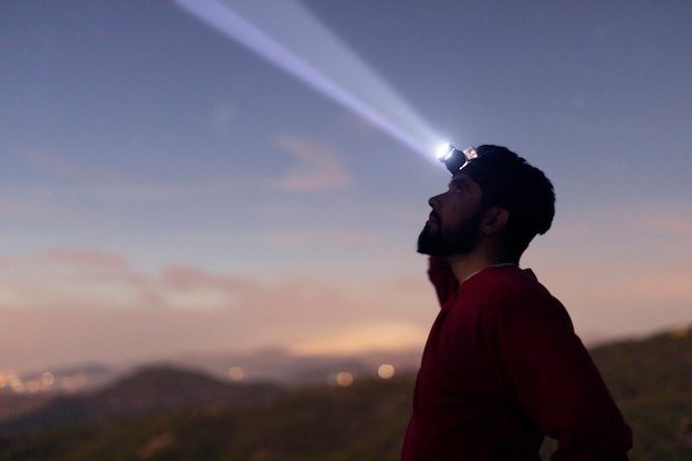 Free photo side view man with head lantern