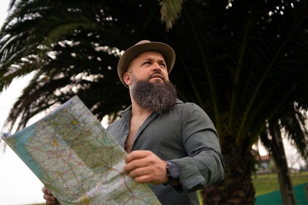 Side view man with map outdoors