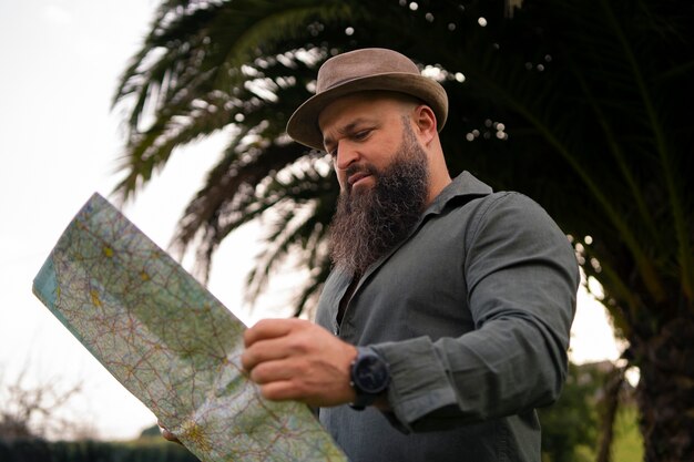 Side view man with map outdoors