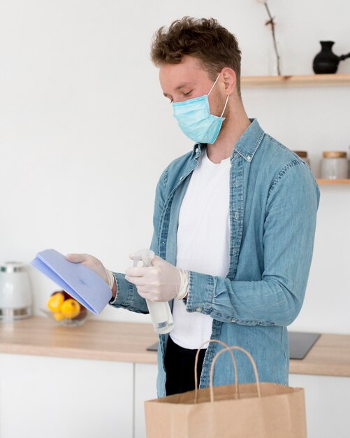 Side view man with mask cleaning