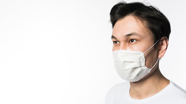 Side view of man with medical mask and copy space