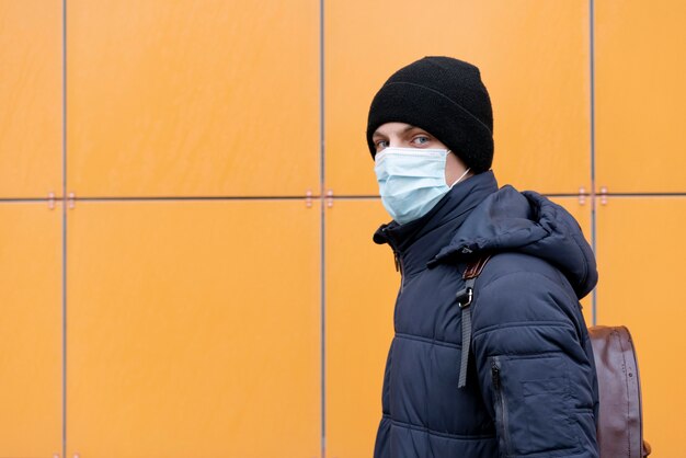 Side view of man with medical mask and copy space