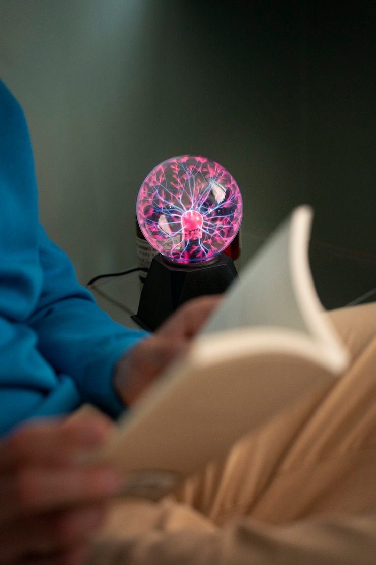 Free Photo side view man with a plasma ball