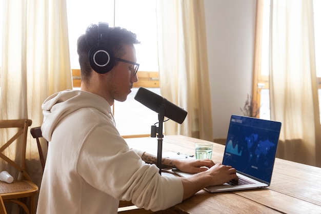 Side view man with podcast equipment