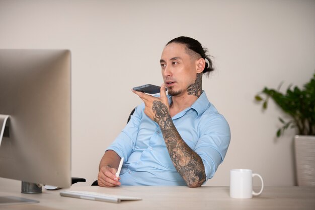 Side view man with smartphone indoors