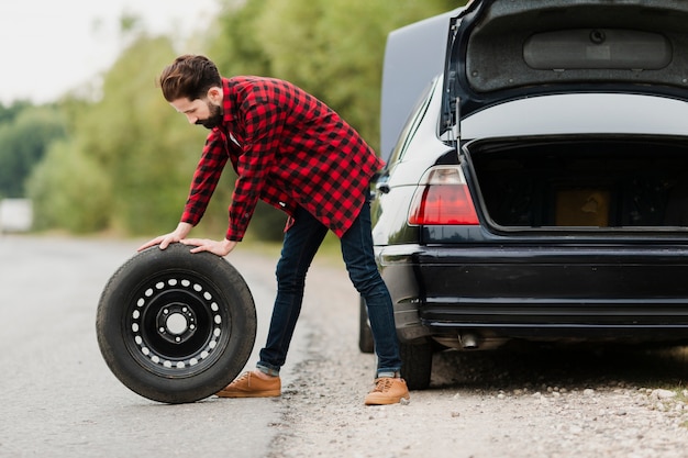 Side view of man with spare tyre