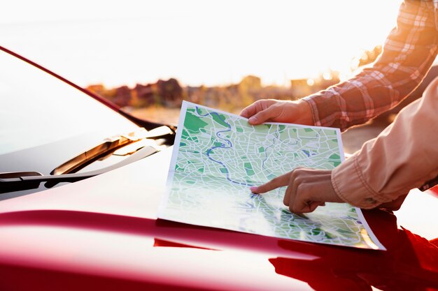 Side view man and woman checking a map