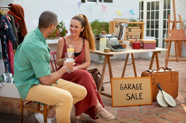 Side view man and woman at garage sale