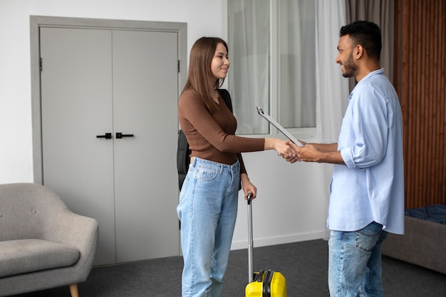 Free photo side view man and woman shaking hands