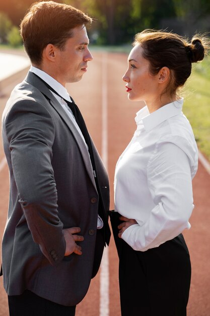 Side view man and woman wearing suits