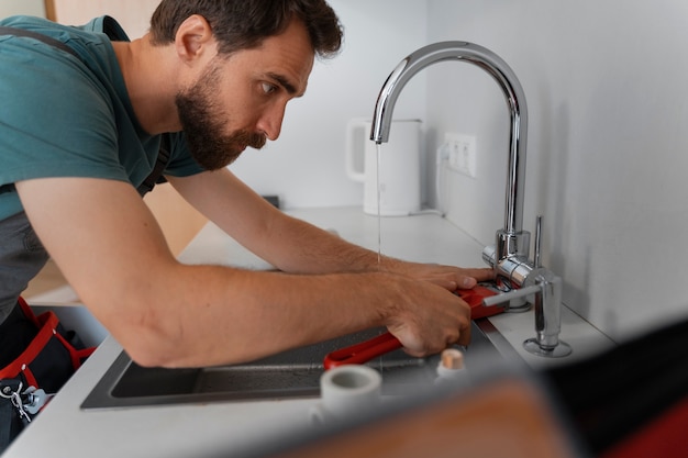 Free photo side view man working as plumber