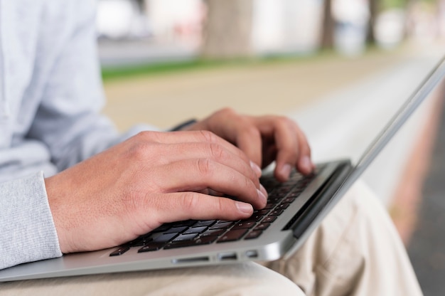 Free photo side view of man working on laptop