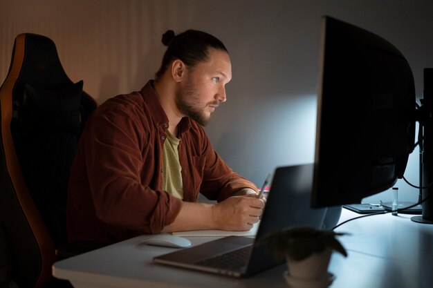 side view man working late at night