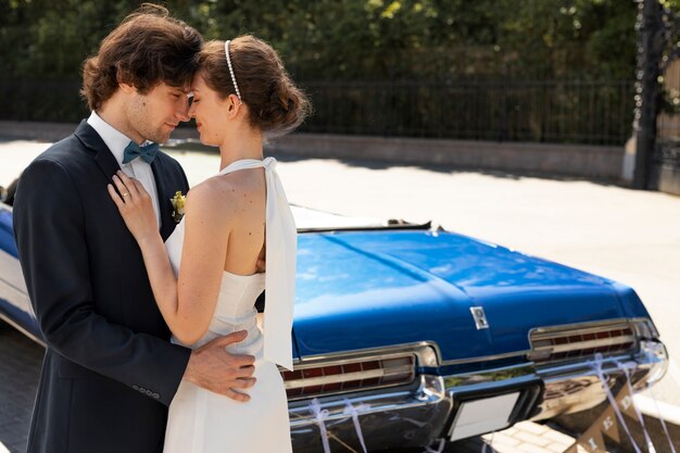 Side view married couple near car