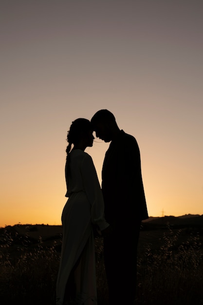 Side view married couple silhouettes