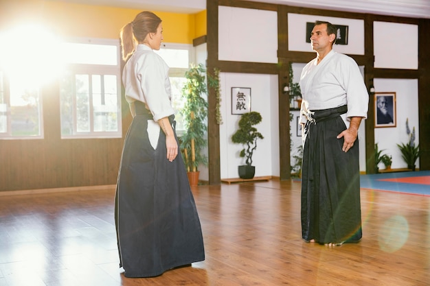 Side view of martial arts instructors training in practice hall