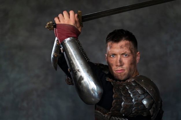 Free photo side view medieval soldier posing in studio