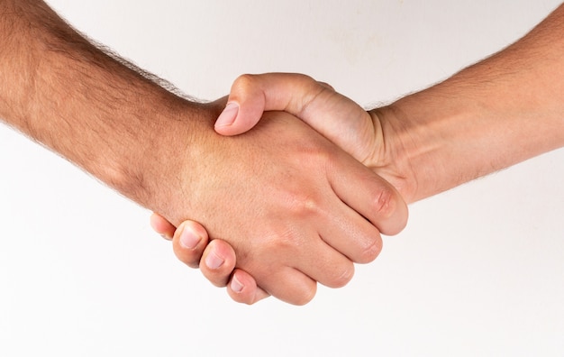 Free photo side view men shaking hands agreement sign