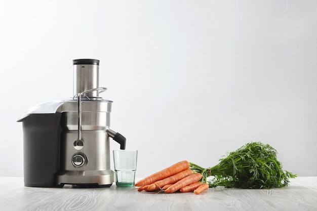 Side view metallic professional juicer with empty glass is prepa