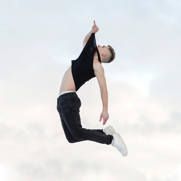 Side view of mid-air pose by hip hop dancer