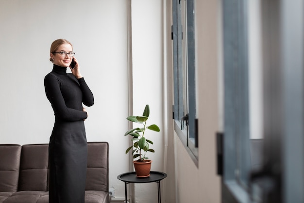 Side view modern female talking over phone