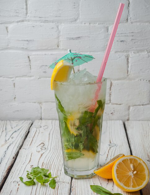 Side view mojito with lemon and juice strawmint in glass cup