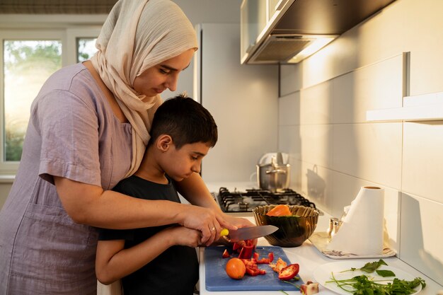 Side view mother and boy cooking