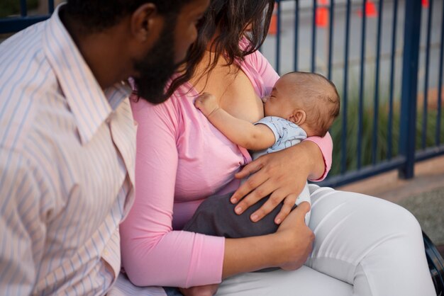 Side view mother breastfeeding baby