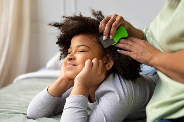 Side view mother combing girl's hair