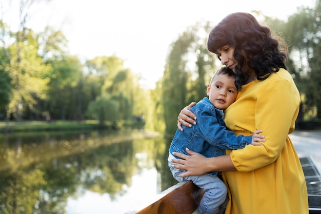 Side view mother holding boy