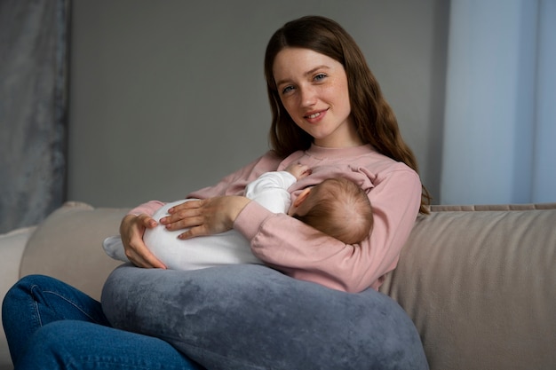 Side view mother with cute newborn