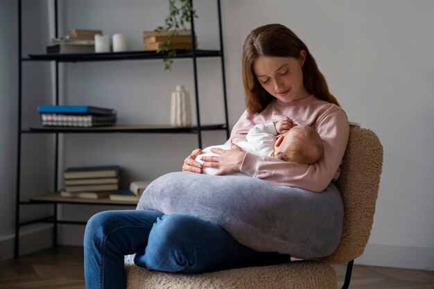 Side view mother with cute newborn