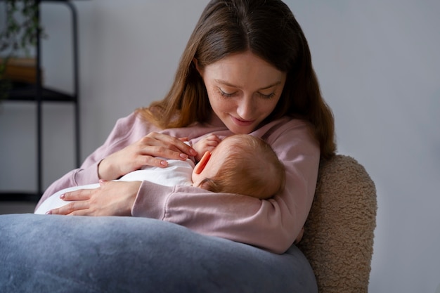 Side view mother with cute newborn